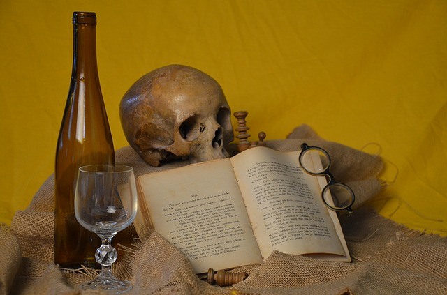 Books bound in human skin featuring a skull and wine glass